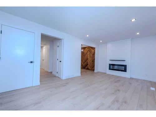 19-11407 Braniff Road Sw, Calgary, AB - Indoor Photo Showing Living Room With Fireplace