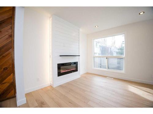 19-11407 Braniff Road Sw, Calgary, AB - Indoor Photo Showing Living Room With Fireplace