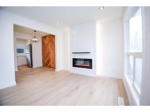 19-11407 Braniff Road Sw, Calgary, AB - Indoor Photo Showing Living Room With Fireplace