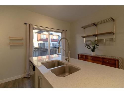 2206 Jumping Pound Common, Cochrane, AB - Indoor Photo Showing Kitchen With Double Sink