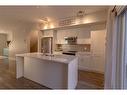 2206 Jumping Pound Common, Cochrane, AB  - Indoor Photo Showing Kitchen With Stainless Steel Kitchen With Double Sink With Upgraded Kitchen 