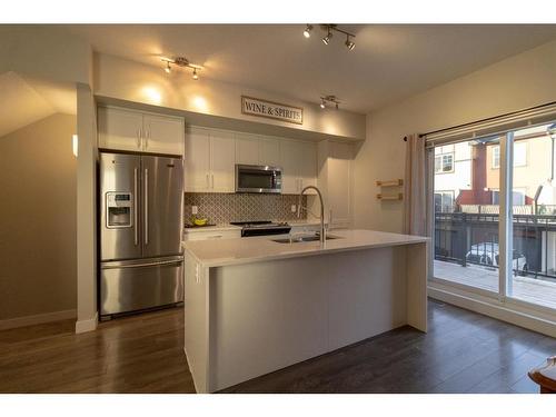 2206 Jumping Pound Common, Cochrane, AB - Indoor Photo Showing Kitchen With Stainless Steel Kitchen