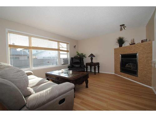 5343 Copperfield Gate Se, Calgary, AB - Indoor Photo Showing Living Room With Fireplace