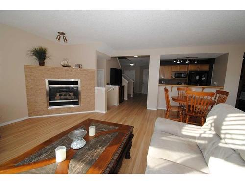 5343 Copperfield Gate Se, Calgary, AB - Indoor Photo Showing Living Room With Fireplace