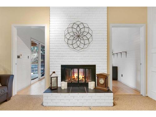 83 Deerbrook Road Se, Calgary, AB - Indoor Photo Showing Living Room With Fireplace