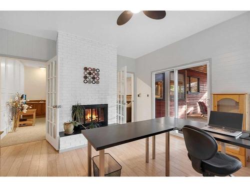 83 Deerbrook Road Se, Calgary, AB - Indoor Photo Showing Office With Fireplace