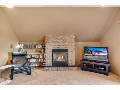 83 Deerbrook Road Se, Calgary, AB - Indoor Photo Showing Other Room With Fireplace