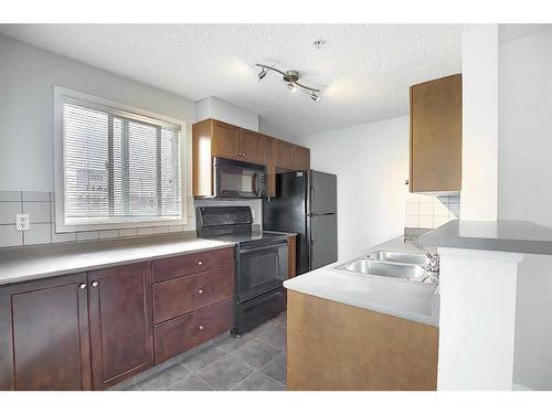 3225-16320 24 Street Sw, Calgary, AB - Indoor Photo Showing Kitchen With Double Sink