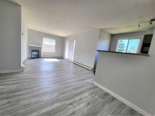 3225-16320 24 Street Sw, Calgary, AB - Indoor Photo Showing Other Room With Fireplace