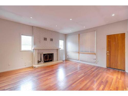 120 6 Avenue Nw, Calgary, AB - Indoor Photo Showing Living Room With Fireplace