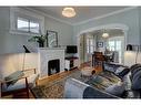 511 10 Avenue Ne, Calgary, AB  - Indoor Photo Showing Living Room With Fireplace 