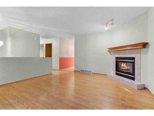 15 Village Green, Carstairs, AB - Indoor Photo Showing Living Room With Fireplace