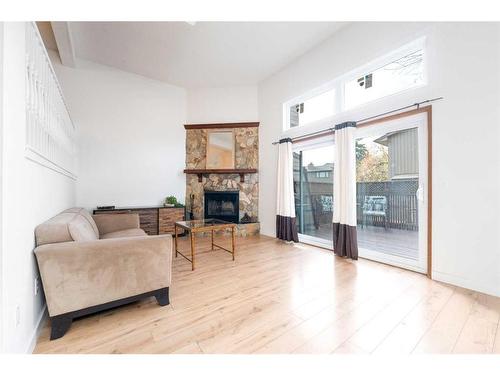 97-23 Glamis Drive Sw, Calgary, AB - Indoor Photo Showing Living Room With Fireplace