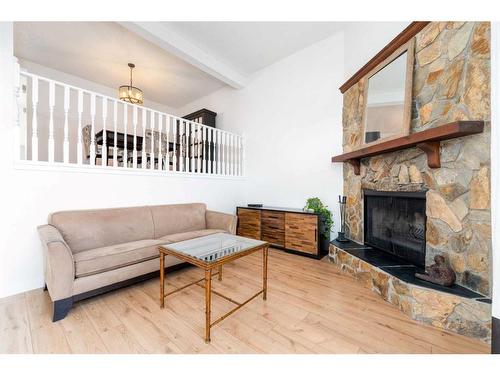 97-23 Glamis Drive Sw, Calgary, AB - Indoor Photo Showing Living Room With Fireplace