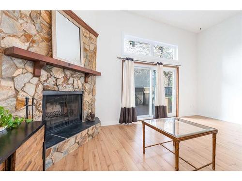 97-23 Glamis Drive Sw, Calgary, AB - Indoor Photo Showing Living Room With Fireplace