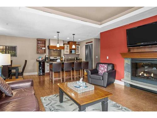 106-173 Kananaskis Way, Canmore, AB - Indoor Photo Showing Living Room With Fireplace