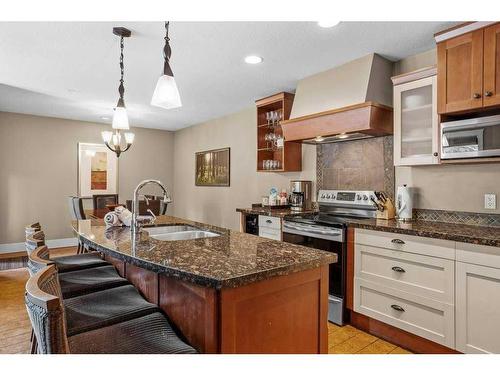 106-173 Kananaskis Way, Canmore, AB - Indoor Photo Showing Kitchen With Double Sink