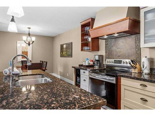 106-173 Kananaskis Way, Canmore, AB - Indoor Photo Showing Kitchen With Double Sink