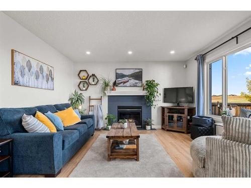 65 Crystal Shores Crescent, Okotoks, AB - Indoor Photo Showing Living Room With Fireplace