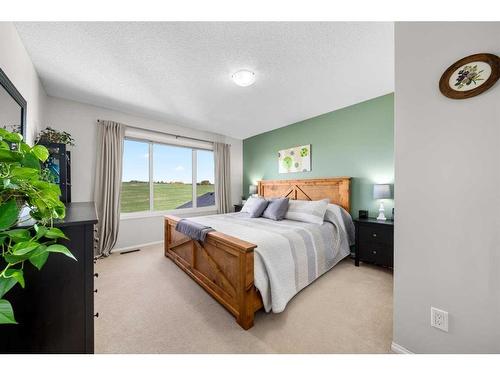 65 Crystal Shores Crescent, Okotoks, AB - Indoor Photo Showing Bedroom