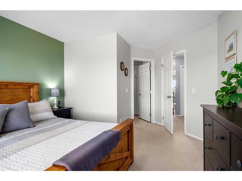 65 Crystal Shores Crescent, Okotoks, AB - Indoor Photo Showing Bedroom