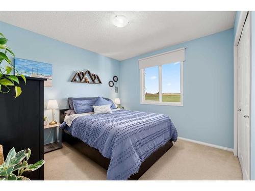 65 Crystal Shores Crescent, Okotoks, AB - Indoor Photo Showing Bedroom