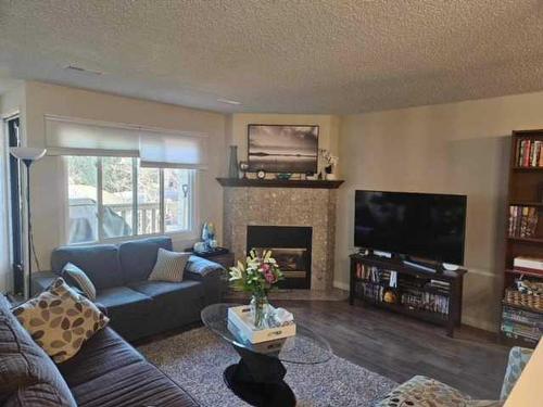 7 Cedar Springs Gardens Sw, Calgary, AB - Indoor Photo Showing Living Room With Fireplace