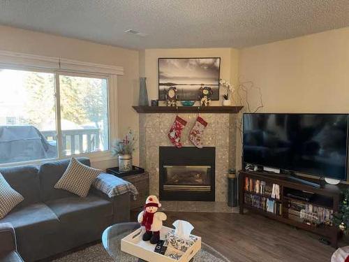 7 Cedar Springs Gardens Sw, Calgary, AB - Indoor Photo Showing Living Room With Fireplace