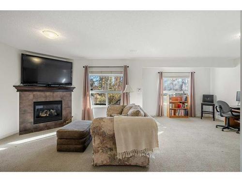 32 St Moritz Terrace Sw, Calgary, AB - Indoor Photo Showing Living Room With Fireplace