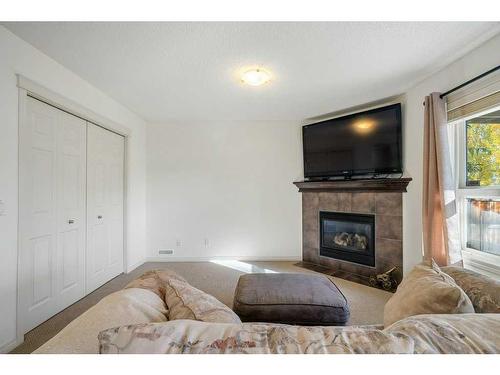 32 St Moritz Terrace Sw, Calgary, AB - Indoor Photo Showing Living Room With Fireplace