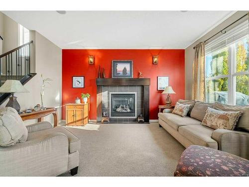 32 St Moritz Terrace Sw, Calgary, AB - Indoor Photo Showing Living Room With Fireplace