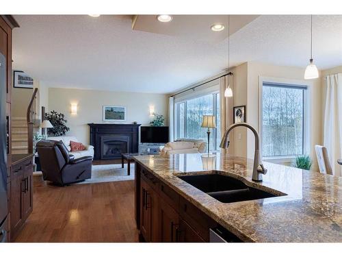 42 Tuscany Estates Crescent Nw, Calgary, AB - Indoor Photo Showing Kitchen With Fireplace With Double Sink