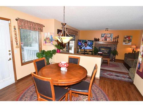 163 Shannon Circle Sw, Calgary, AB - Indoor Photo Showing Dining Room With Fireplace