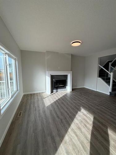 1607 Baywater Street Sw, Airdrie, AB - Indoor Photo Showing Living Room With Fireplace