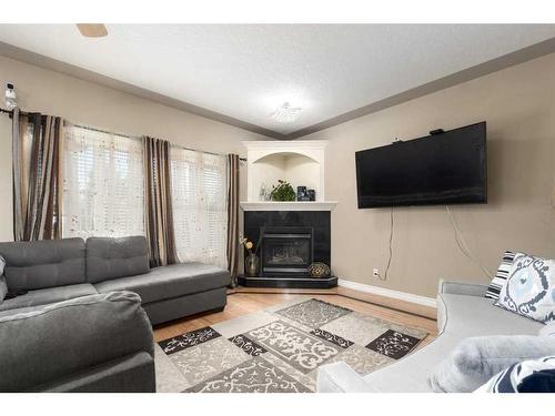 75 West Cedar Rise Sw, Calgary, AB - Indoor Photo Showing Living Room With Fireplace