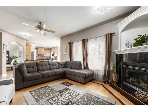 75 West Cedar Rise Sw, Calgary, AB - Indoor Photo Showing Living Room With Fireplace