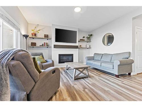 1064 Chinook Gate Heath Sw, Airdrie, AB - Indoor Photo Showing Living Room With Fireplace