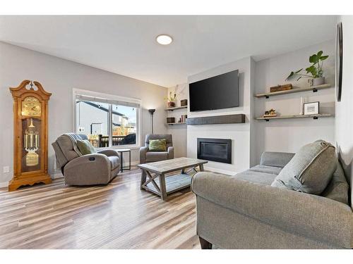 1064 Chinook Gate Heath Sw, Airdrie, AB - Indoor Photo Showing Living Room With Fireplace