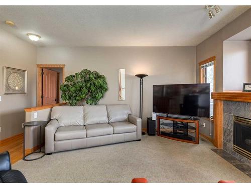 130 Scimitar Point Nw, Calgary, AB - Indoor Photo Showing Living Room With Fireplace