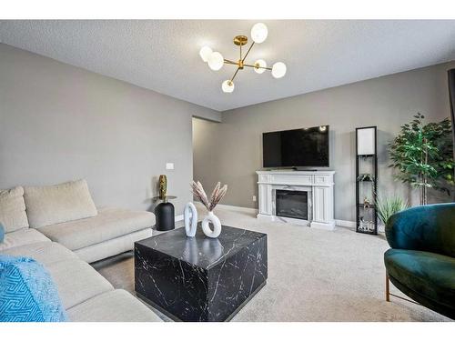 528 Sage Hill Grove Nw, Calgary, AB - Indoor Photo Showing Living Room With Fireplace