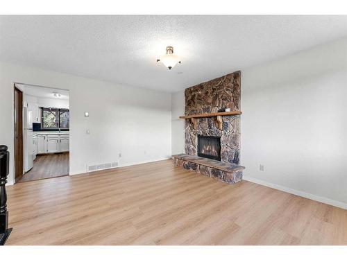 12 Glenport Road, Cochrane, AB - Indoor Photo Showing Living Room With Fireplace