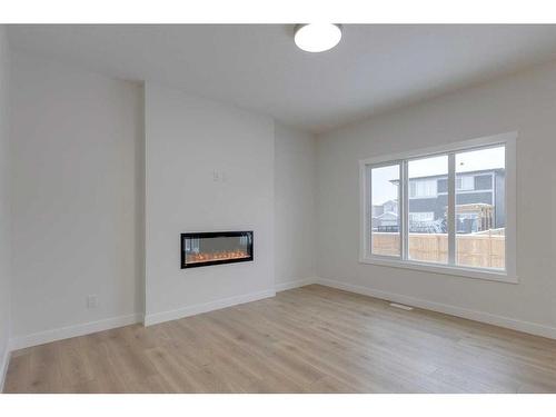 70 Saddlebred Place, Cochrane, AB - Indoor Photo Showing Other Room With Fireplace