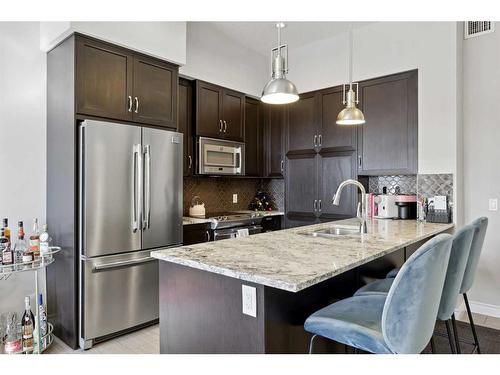 311-39 Quarry Gate Se, Calgary, AB - Indoor Photo Showing Kitchen With Stainless Steel Kitchen With Upgraded Kitchen