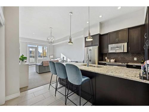 311-39 Quarry Gate Se, Calgary, AB - Indoor Photo Showing Kitchen With Stainless Steel Kitchen With Upgraded Kitchen