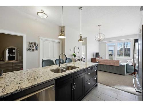 311-39 Quarry Gate Se, Calgary, AB - Indoor Photo Showing Kitchen With Double Sink With Upgraded Kitchen