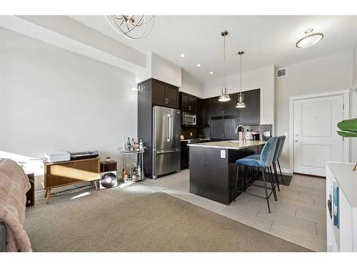 311-39 Quarry Gate Se, Calgary, AB - Indoor Photo Showing Kitchen With Stainless Steel Kitchen With Upgraded Kitchen