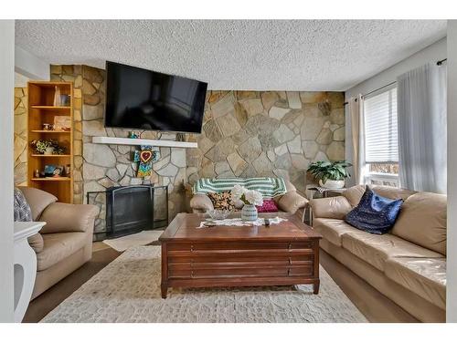 39 Strathclair Rise Sw, Calgary, AB - Indoor Photo Showing Living Room With Fireplace