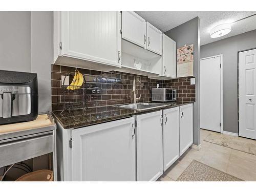 330-820 89 Avenue Sw, Calgary, AB - Indoor Photo Showing Kitchen With Double Sink