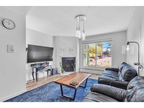 9101-315, Southampton Drive Sw, Calgary, AB - Indoor Photo Showing Living Room With Fireplace