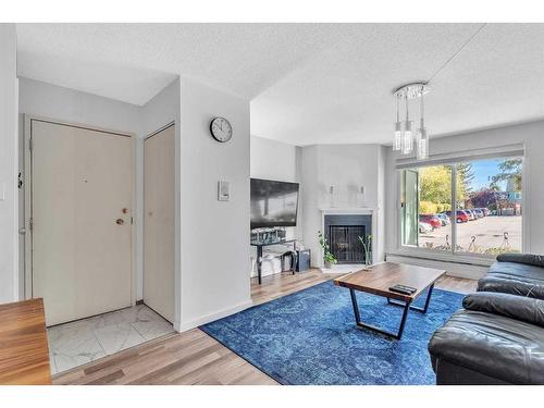 9101-315, Southampton Drive Sw, Calgary, AB - Indoor Photo Showing Living Room With Fireplace